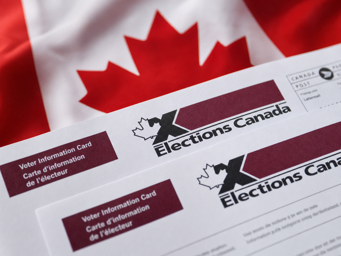 Elections Canada voter information cards on a Canadian flag